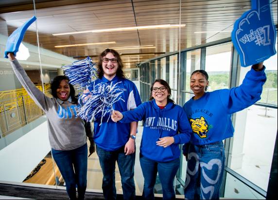 students holding foam finger