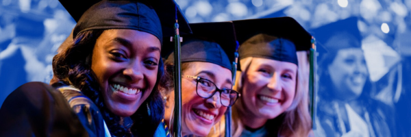 Three graduates looking at the camera and smiling.