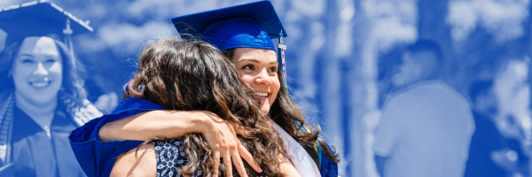 Graduate hugging a loved one. Another graduate and guest are in the background.