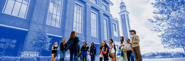 Student tour guide giving a campus tour in front of the Student Center.