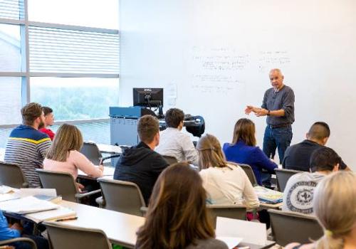 A Professor Speaks to Students in a UNT Dallas School of Business Marketing Class
