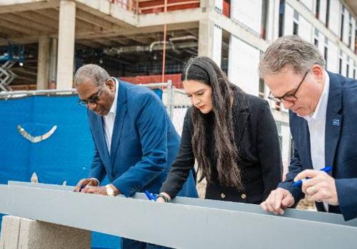 Alex Renteria Signs the Final Steel Beam on the New UNT Dallas STEM Building with University President Dr. Warren von Eschenbach and State Sen. Royce West