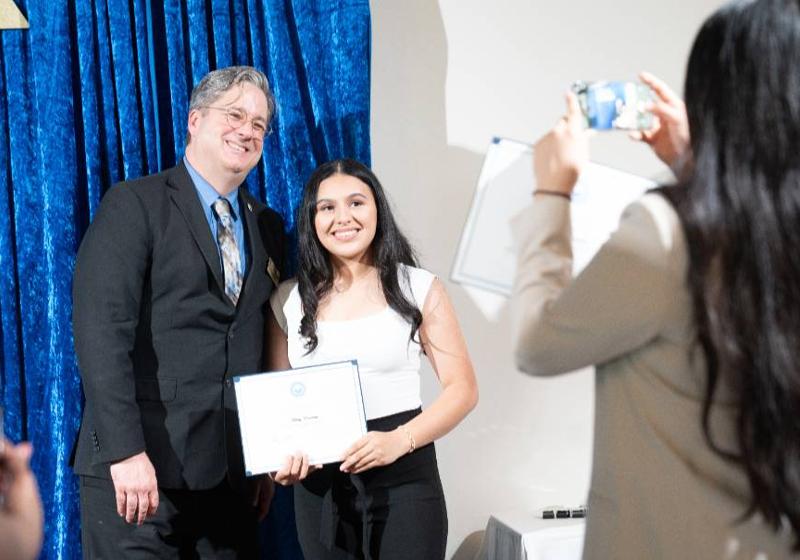 Ashley Renteria Accepting Her School of Business Excellence Award with Dean Jason Garrett