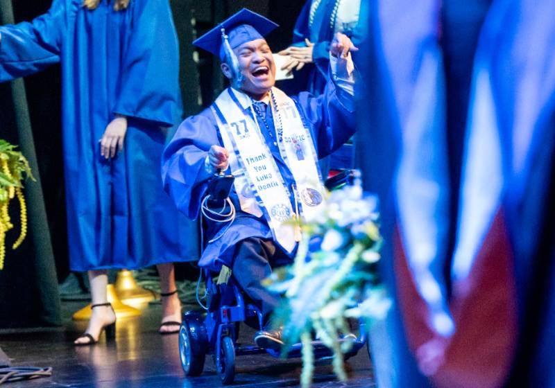 A Graduate Smiles with Pride and Joy As His Name Is Called During Commencement
