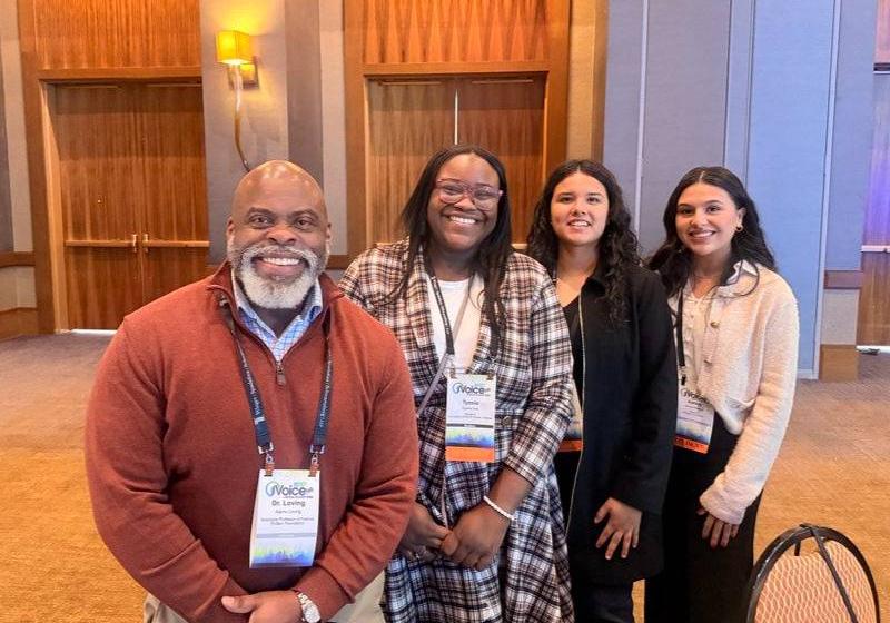 Ashley Renteria with Dr. Ajamu Loving and Two Others at Finance Conference