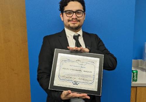 Edvin Arriaza Holds His "Self Destruct" Award from the UNT Dallas eSports Team