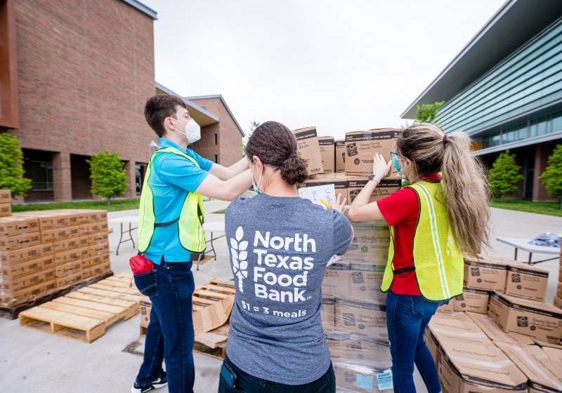 Volunteers from North Texas Food Bank Unload Pallets of Products at a Mobile Food Pantry Distribution on the UNT Dallas Campus