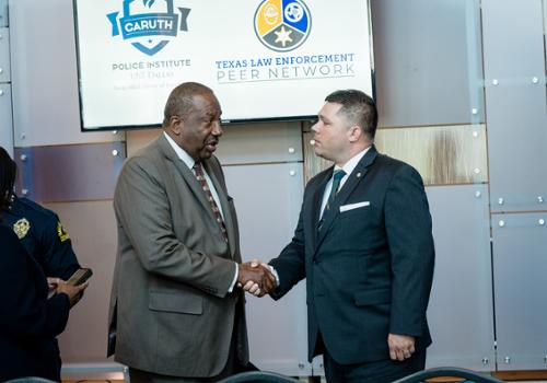 West and Schellenger shaking hands