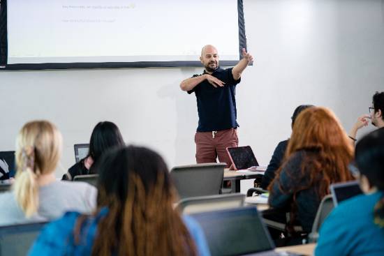 Robert Tinajero, Associate Professor of English and Rhetoric, Makes a Point to Students During An English Class