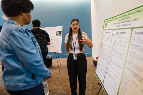 Adilene Garibay Explains Her Research Project to Provost Betty Stewart During the UNT Dallas Student Research Symposium