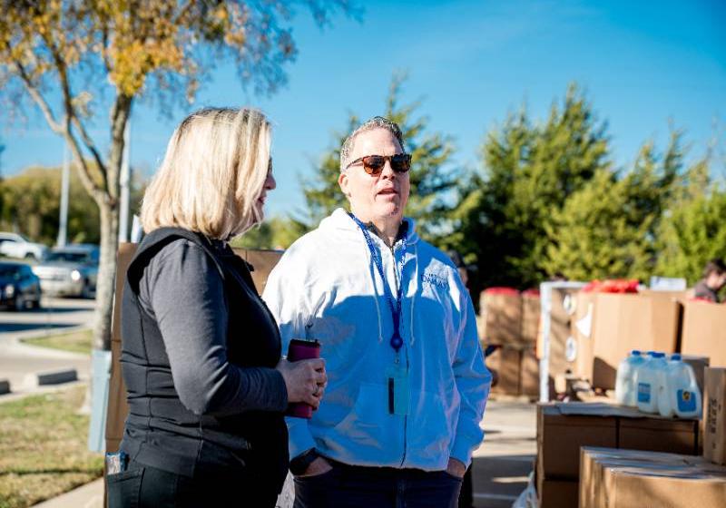President Dr. Warren von Eschenbach Speaks with a Volunteer at a UNT Dallas-NTFB Mobile Food Pantry Distribution