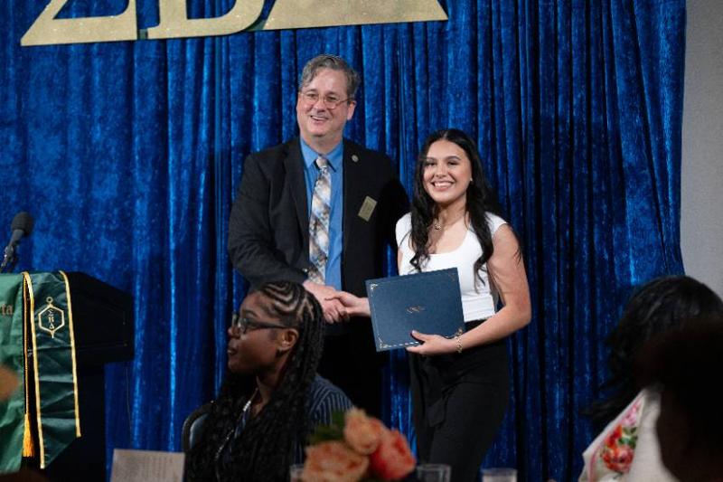 School of Business Dean, Dr. Jason Garrett, Presents an Award to a Student at the School's Annual Spring Gala