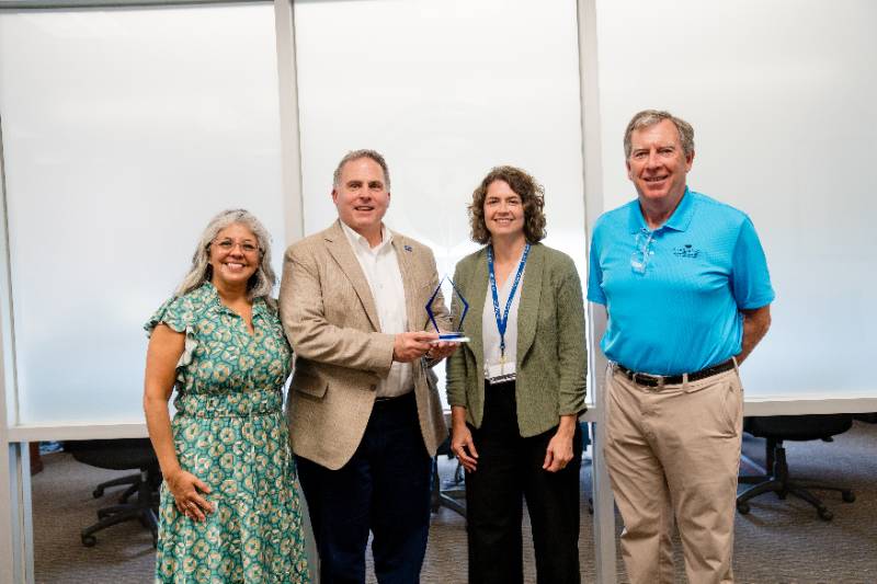 President Warren von Eschenbach and Kim Chandler, Associate VP for Strategy and Effectiveness, Receive the 2024 Texas University Report Card Award from ScholarShot's Dan Hooper and Christina Etri