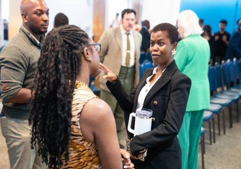 Abba Keren Koffi (second from right) Talks with a Student at a School of Business Career Event