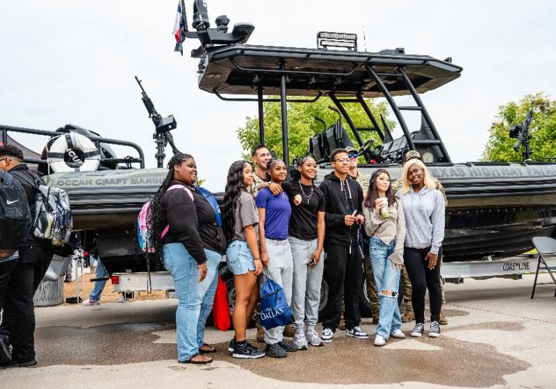 Students Standing in Front of a Texas Parks and Wildlife Dept. Boat