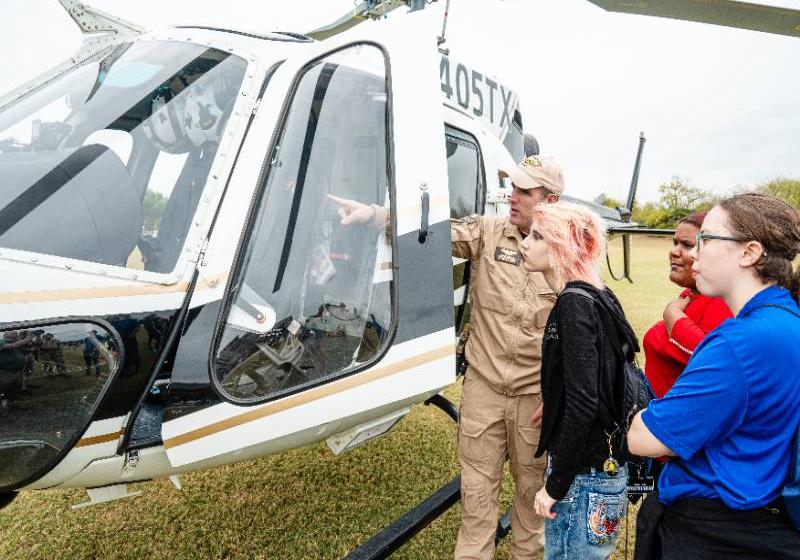 A State Trooper Shows a Texas DPS Helicopter to Visiting High School Students