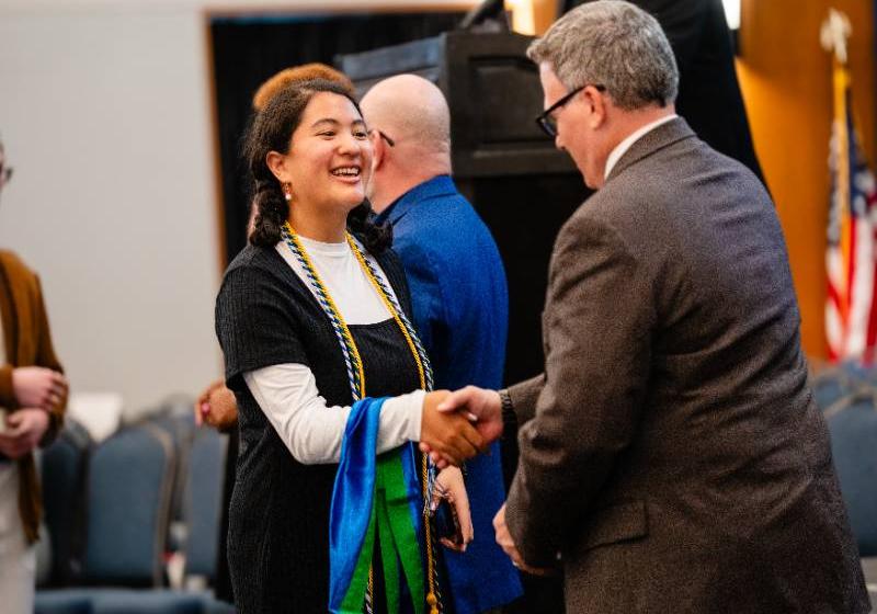 Isabelle Chung Greeted by UNT Dallas President Dr. Warren von Eschenbach at the Fall 2025 Cord & Ring Ceremony