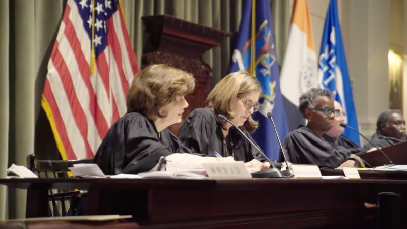 Judges Listen and Take Notes During the National Moot Court Competition