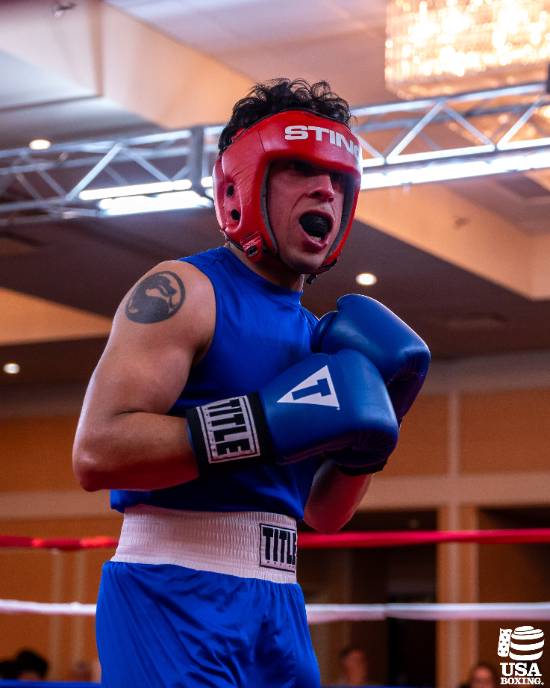 Noe Mendoza, a 2L Student at UNT Dallas College of Law, in the Boxing Ring During a Collegiate Match