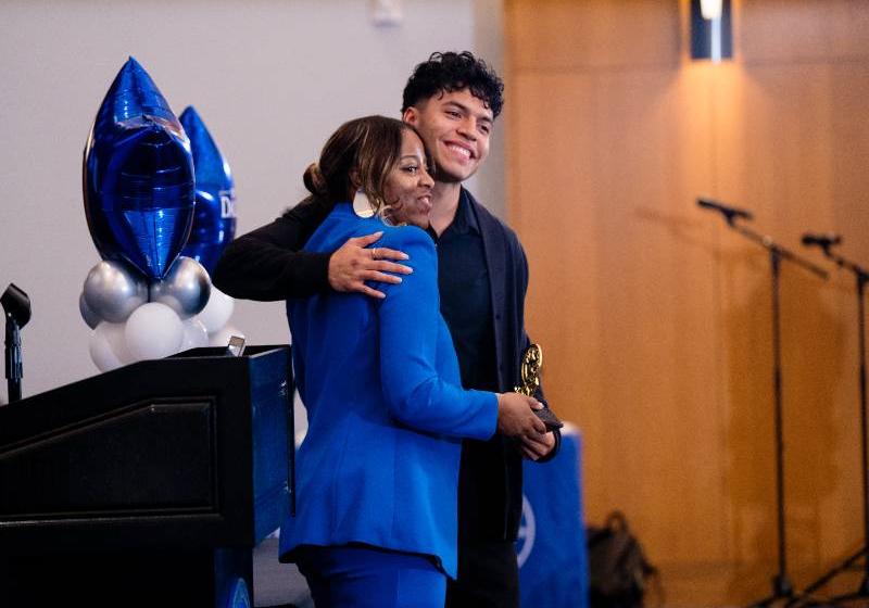 Dr. Kimberly Riddick Hugs Senior Sergio Barrera at a Trailblazer Elite Recognition Event