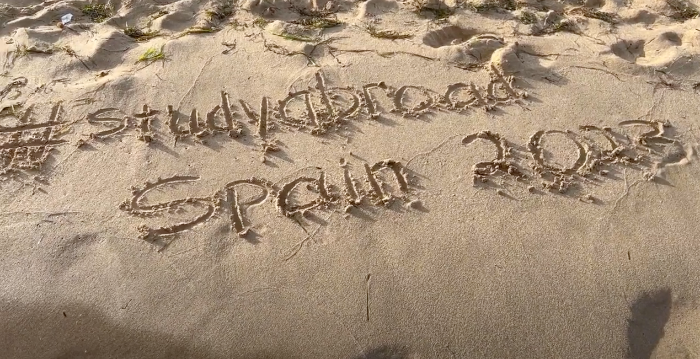 A Message In the Sand on a Spanish Written by UNT Dallas Study Abroad Students