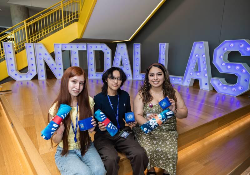 students in front of untd sign
