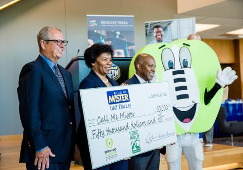 provost stewart holding giant check with donors