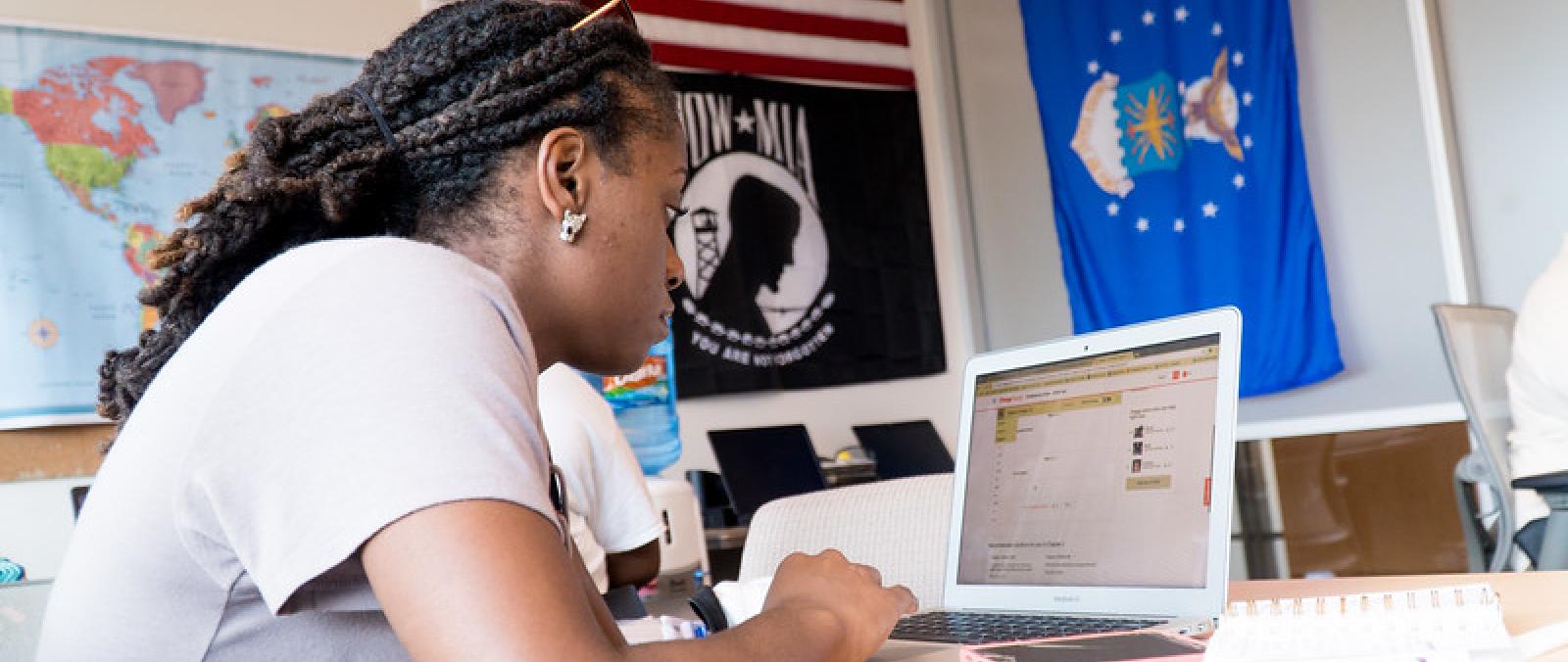 Student Veteran at laptop in veteran success center