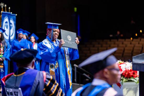 graduate on stage at ceremony