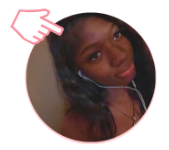 brown skin woman smiling with earbuds and hair down