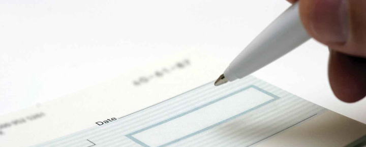 Cropped view of pen over the date section of a check