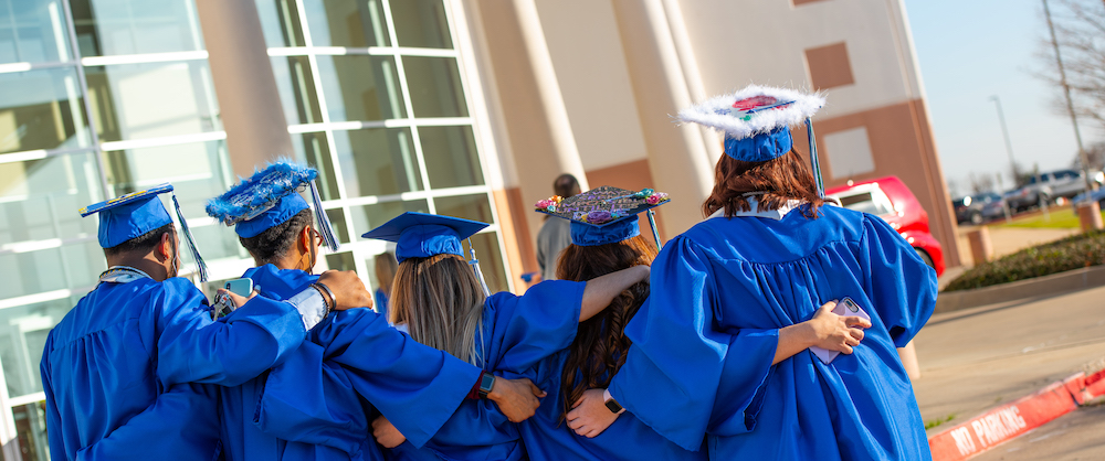 rear view of graduates posing in line