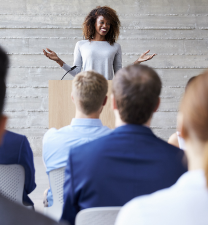 woman speaking at podium